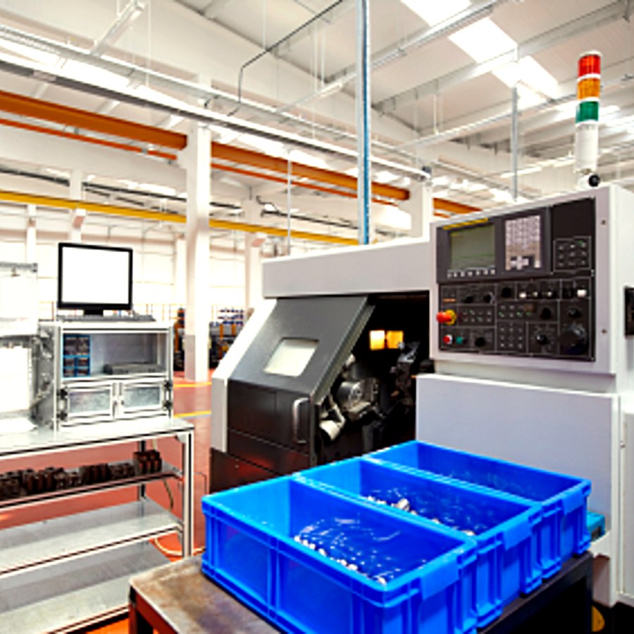 CNC lathe with machined parts collected in bins for inspection