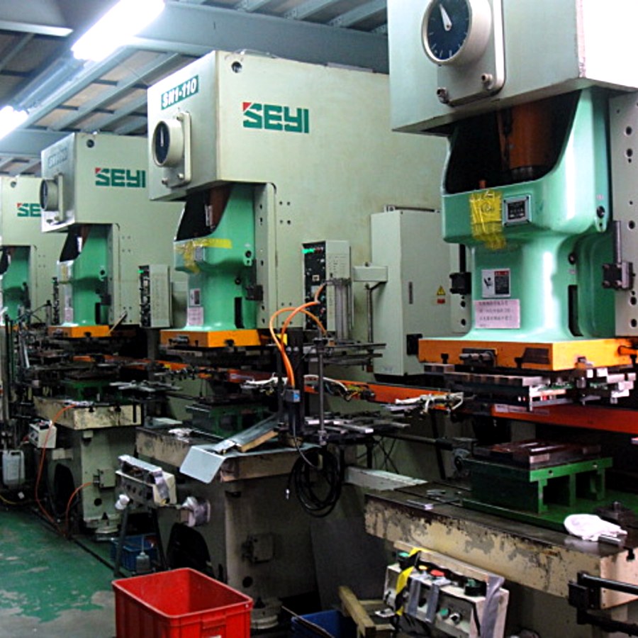 Stamping press line with progressive dies in sequence